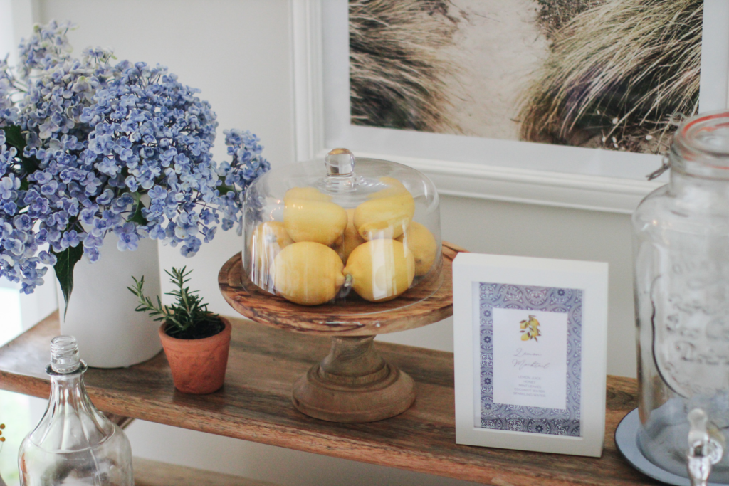 Mediterranean-inspired party table decorated with lemons and fresh flowers