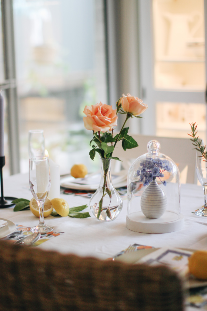 Mediterranean-inspired party details featuring fresh flowers and citrus