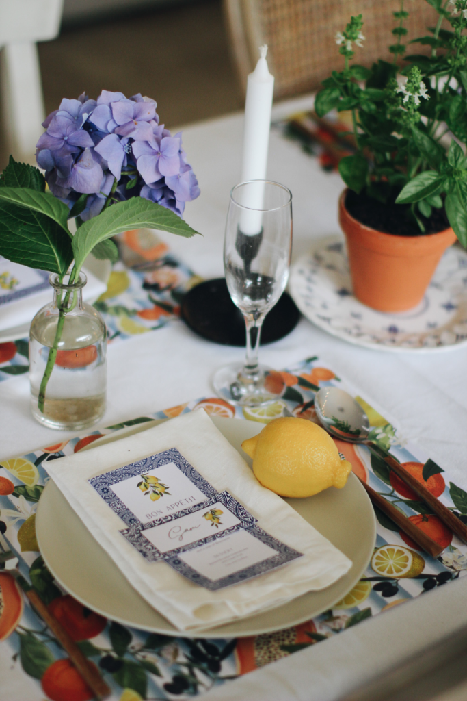 Italian-inspired table styling with fresh lemons, linen napkins, and floral arrangements